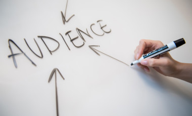 Writing in whiteboard with pointed arrows to the word 'Audience'
