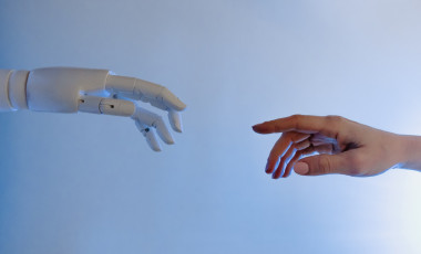 A person reaching out to a robot, imitating Michelangelo's Fresco painting 'Creazione di Adamo' | Image Courtesy: Tara Winstead, Pexels